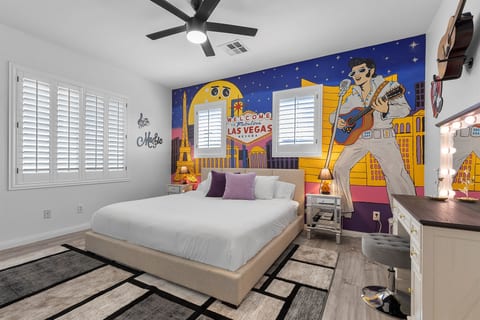 Famous Las Vegas performers themed bedroom with a King bed and custom hand-drawn artwork. All bedrooms have a 55" 4K TV. It’s Showtime!