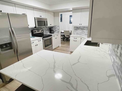 Kitchen with stove, microwave, refrigerator, dish washer