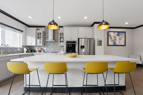 Bright modern kitchen with oversized island seating for four