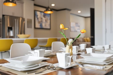 Modern open dining space with chef’s kitchen and seating for a group