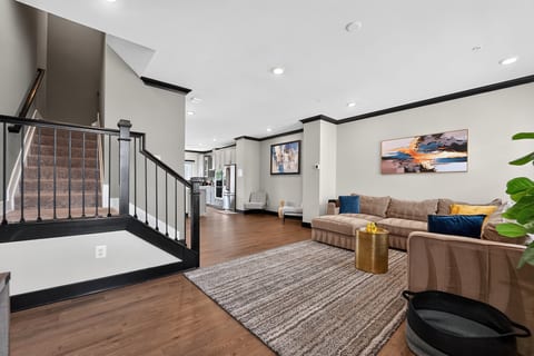 Spacious open living area with stylish decor, cozy seating, and modern finishes
