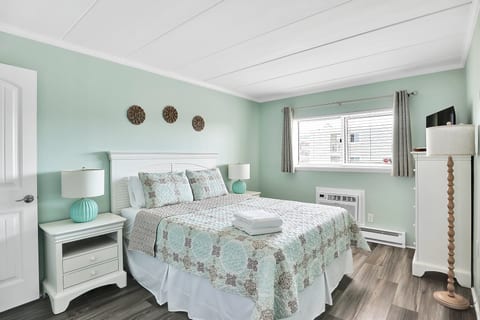 Bright coastal-style bedroom with natural light and calming decor
