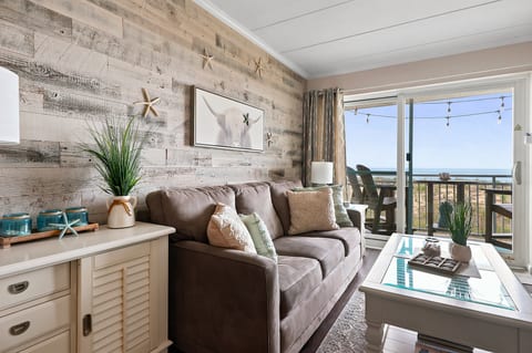 Cozy coastal living room with private balcony and beautiful ocean views