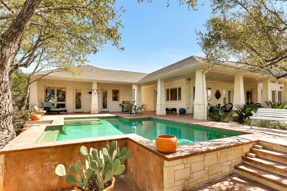 Private pool and shaded patio at this spacious Lago Vista ranch home, perfect for relaxing, swimming, and enjoying Texas Hill Country sunshine