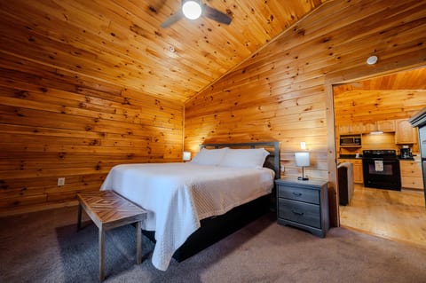 King sized bedroom with walkout to rear deck