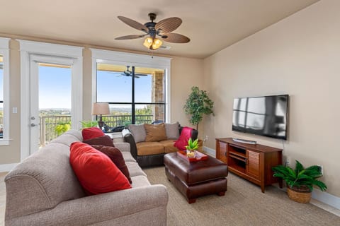 Bright, open living area with comfortable seating, large windows, and easy access to the balcony for indoor-outdoor relaxation