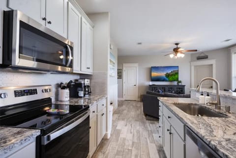 Fully equipped kitchen with stainless steel appliances, granite countertops, and an island for easy meals during your stay