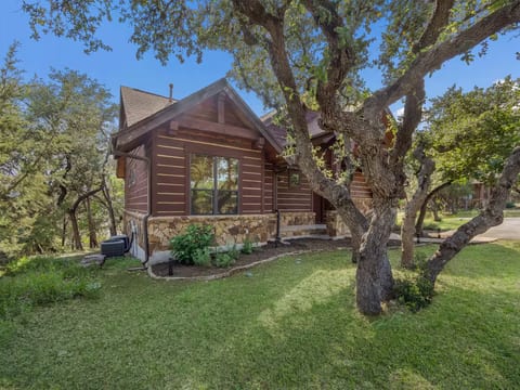 Private wooded retreat with cabin-style charm, surrounded by mature trees and peaceful outdoor scenery in secluded Hill Country Setting
