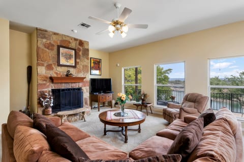 Living area with wood burning fireplace and wide screen TV