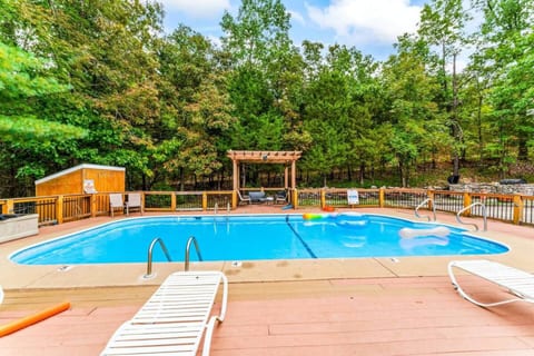 Outdoor community pool area, lounge chairs and plenty of trees create a relaxing space for families to come and play!