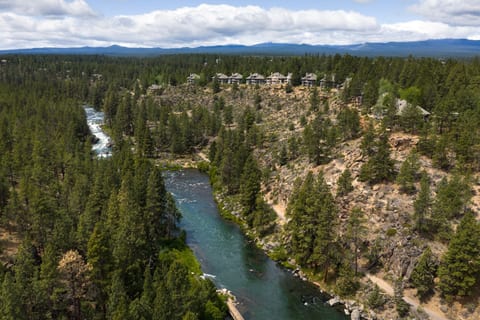 Scenic riverside setting with forest, canyon views, and mountain backdrop