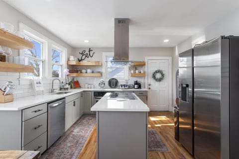 Sunlit space with sleek appliances and charming decor for great culinary experiences!