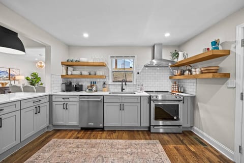 Fully equipped chef’s kitchen featuring high-end appliances and all the essentials for a gourmet meal — including KitchenAid range and mixer, Nespresso, Keurig, and an array of quality cookware and utensils.