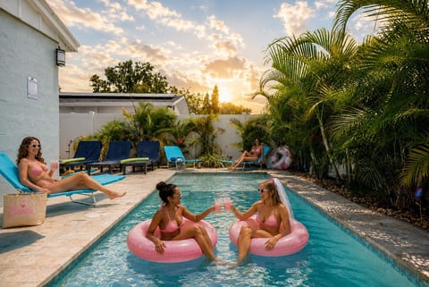 Private pool deck with lounge chairs, pool noodles, and floats included. Fully fenced, tropical landscaping, sleeps 10. Gulfport/South St. Pete, FL.