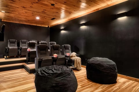 Private home theater with recliners, cozy lighting, and extra lounge seating