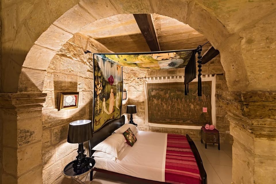 The chapel bedroom.
Romantic double bedroom beneath a historic stone arch, in the old house chapel, with fine linens, and a canopy inspired by Bosch comes with aircondition and a luxurious double shower ensuite.