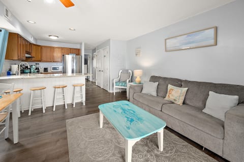Living room with beachy decor and queen sleeper sofa.