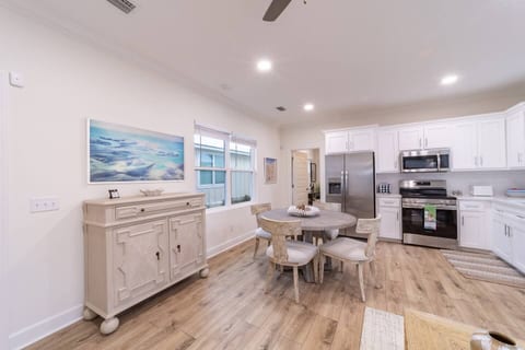 Bright, open kitchen and dining area with modern appliances, white cabinetry, and a cozy rustic table - perfect for cooking and gathering.
New Samsung Frame TV that visible from the living room area, which also doubles as wall art when not in use.