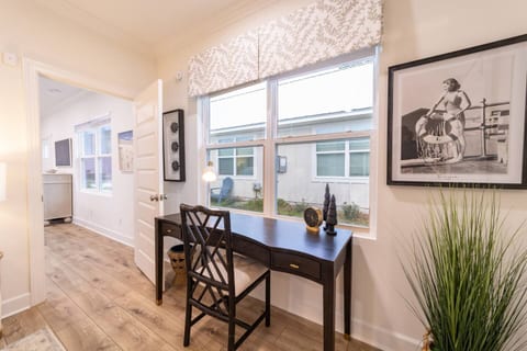 This dedicated workspace is located in Bedroom 1, to the right of the queen bed.