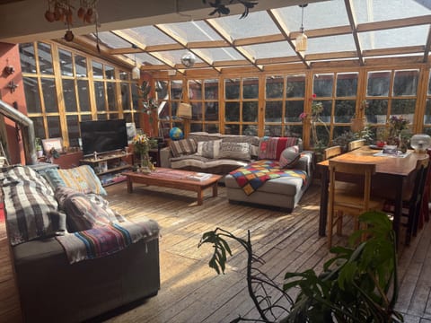 Cozy sunlit wooden chalet with plenty of greenery