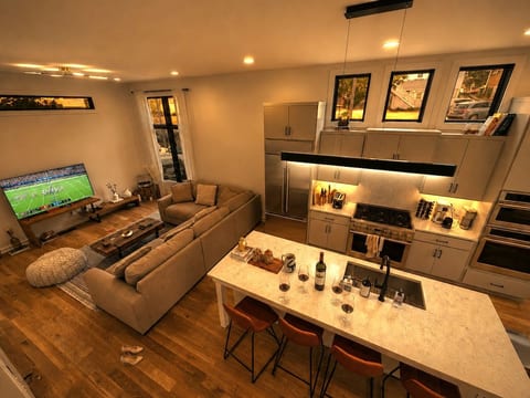 Game night in — Smart HD TV, sofa for 8, kitchen island with wine glasses — Saturday night doesn't need a reservation