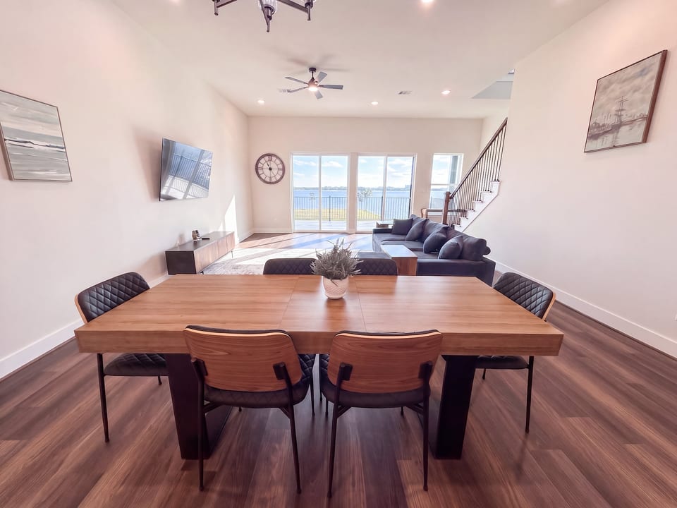 Bright open living space with waterfront views and stylish modern dining