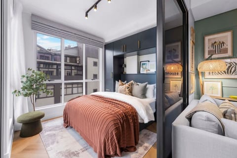 Settle into a beautifully appointed one-bedroom apartment designed for relaxed stays, with a fully equipped kitchen, inviting living room, private balcony, and modern shower.