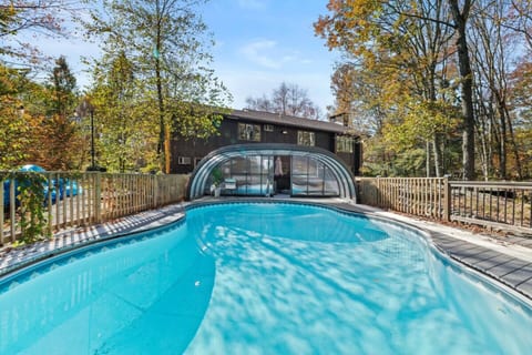 Heated indoor-outdoor pool with retractable enclosure — enjoy swimming year-round