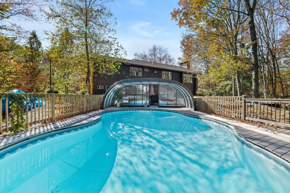 Heated indoor-outdoor pool with retractable enclosure — enjoy swimming year-round