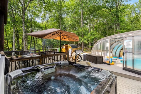 ⭐ One of our guests' favorite amenities—relax in the hot tub while overlooking the year-round indoor pool and barrel sauna