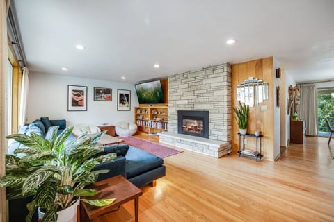 Bright and cozy living space with a modern fireplace, stylish decor, and plenty of natural light – the perfect spot to relax and unwind!