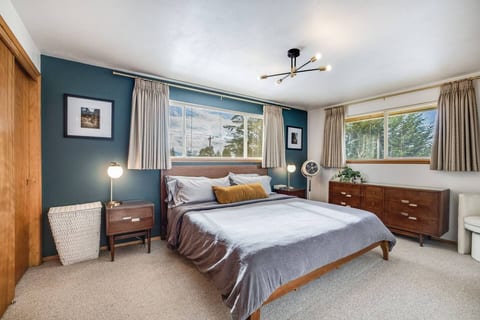 This bedroom features a cozy design with a comfortable queen bed and warm decor.