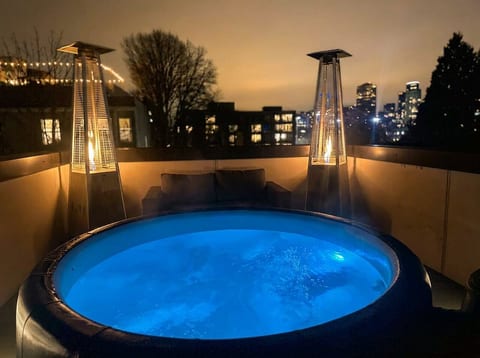 Rooftop hot tub with skyline views and heaters—soak under the stars.