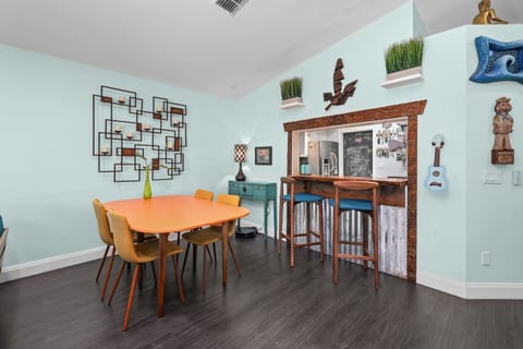 There is a dining table and bar area
