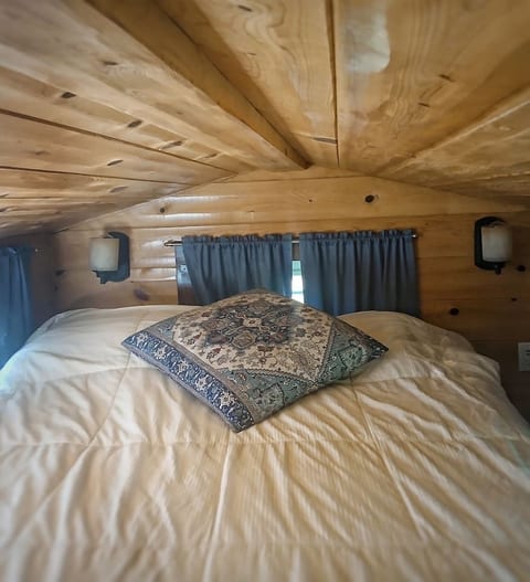 A comfy queen bed is in the loft! Access is a steep staircase made of shelves. Not recommended for those with mobility issues.