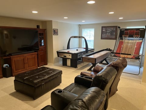 Play, compete, and stream in the basement game room with PS5 and 75-inch smart TV