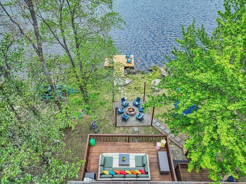 Step outside to a beautifully designed backyard with a spacious deck, stylish outdoor furniture, a firepit, and stunning lake views—perfect for relaxing and gathering.