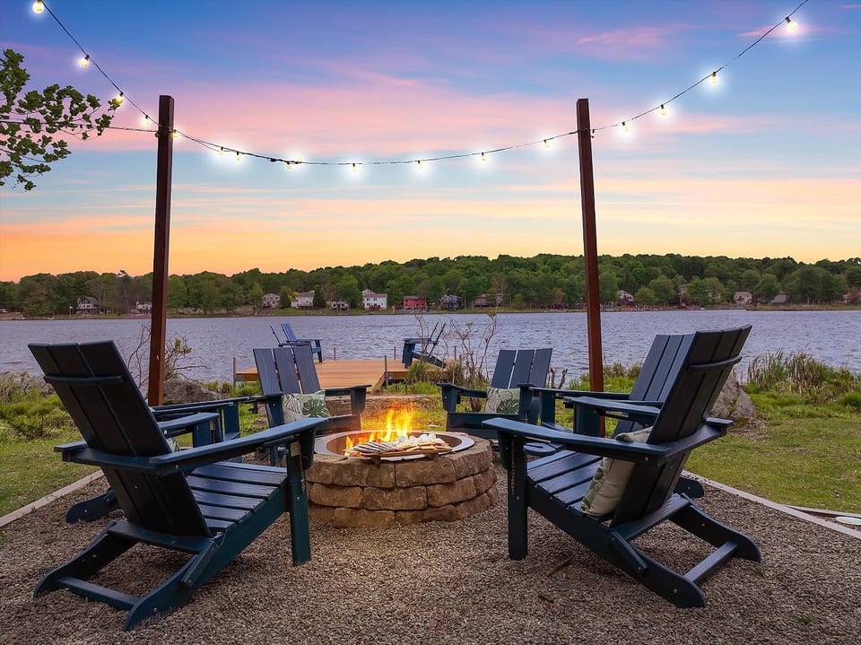 Experience magical twilight moments by the firepit, set beside the dock with serene lakefront views.