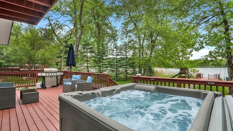 Soak in the hot tub while enjoying peaceful lake views from the deck.