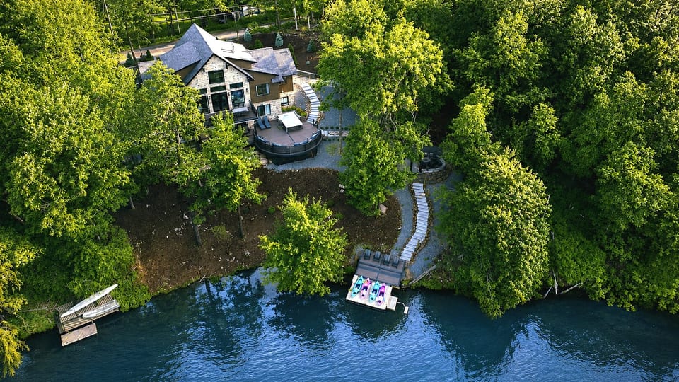 Your private waterfront retreat. From the hot tub and fire pit to the private dock, kayaks, and spacious outdoor gathering areas, every backyard amenity is designed for unforgettable moments by the lake.