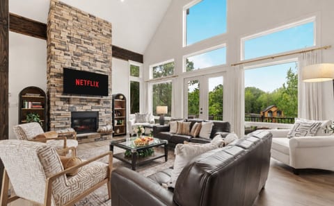 Bright, cozy, and designed for comfort. Unwind in the spacious living area with comfortable seating, a fireplace, Smart TV, and floor-to-ceiling windows that bring the outdoors in.