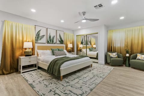 King primary suite with green and gold accents, a smart TV and ceiling fan. Your own retreat at the end of the day.