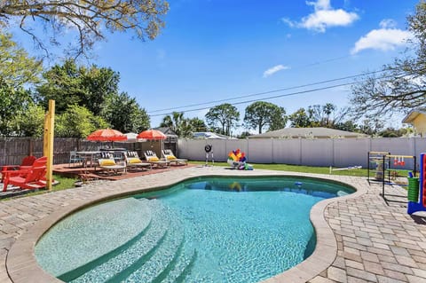 Relax poolside with sun loungers and an umbrella for the perfect balance of sun and shade.