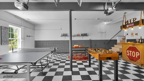 Hours of fun await in the first-floor game room featuring ping pong, foosball, board games, and a cozy bar area.
