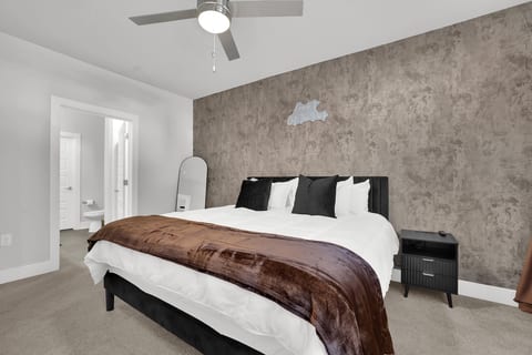 Primary suite with a plush king bed, luxury linens, and calming designer finishes.