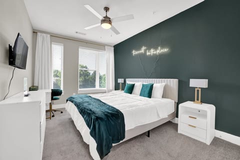 Retreat to the elegant king suite featuring luxury bedding, Smart TV, and a dedicated workspace.