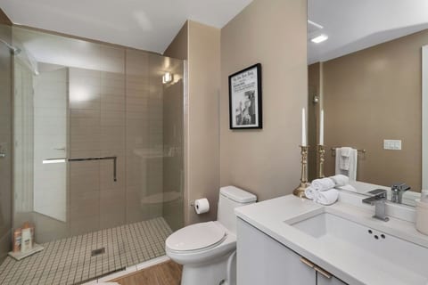 Bathroom with a glass-enclosed walk-in shower and vanity.