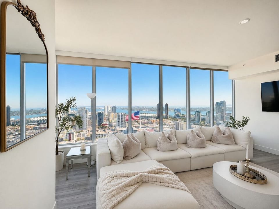 Bright living room with panoramic city and water views from the 35th floor.