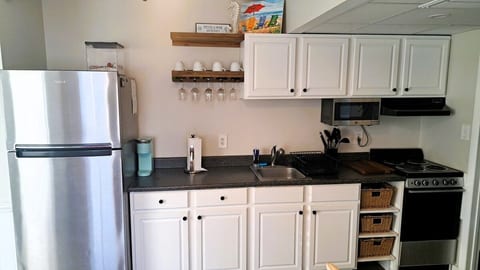 Fully stocked kitchen with refrigerator/freezer, electric stove and oven, microwave, Keurig and standard coffee maker, toaster, flat top griddle, pots/pans, baking sheets, utensils, etc.