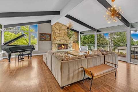 Grand living area with floor-to-ceiling views. Cozy fireplace and vaulted ceilings for the ultimate World Cup 2026 retreat.